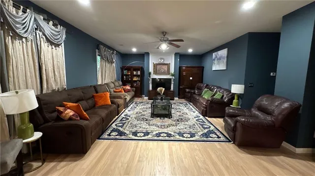 a living room with furniture and wooden floor