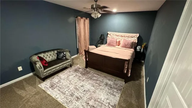 a bedroom with a bed and a couch