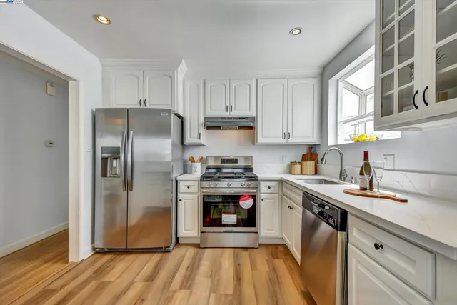 a kitchen with stainless steel appliances granite countertop a stove and a refrigerator