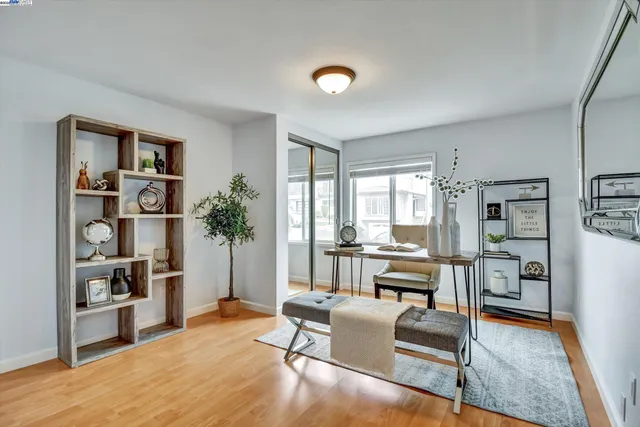 a living room with furniture and a book shelf