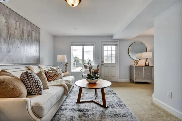 a living room with furniture a rug and a lamp