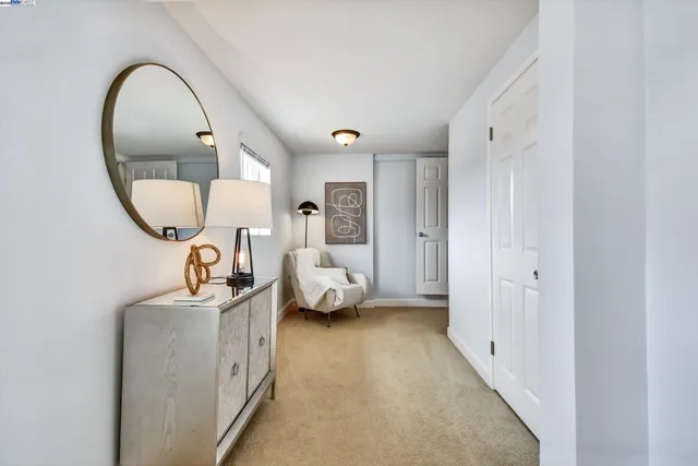 a bed room with a bed and a mirror