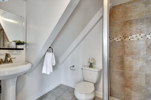 a bathroom with a sink a toilet and shower curtain