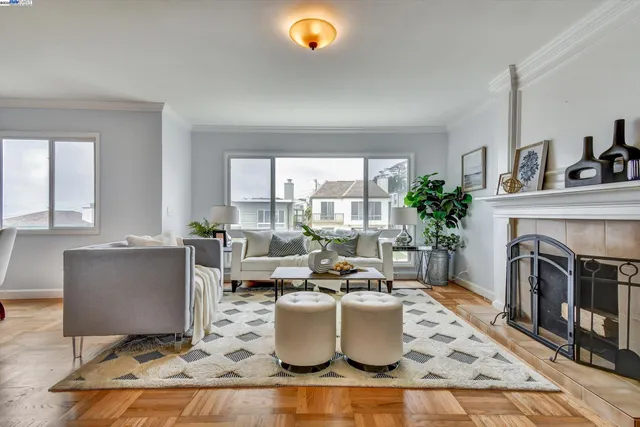 a living room with a fireplace and a floor to ceiling window