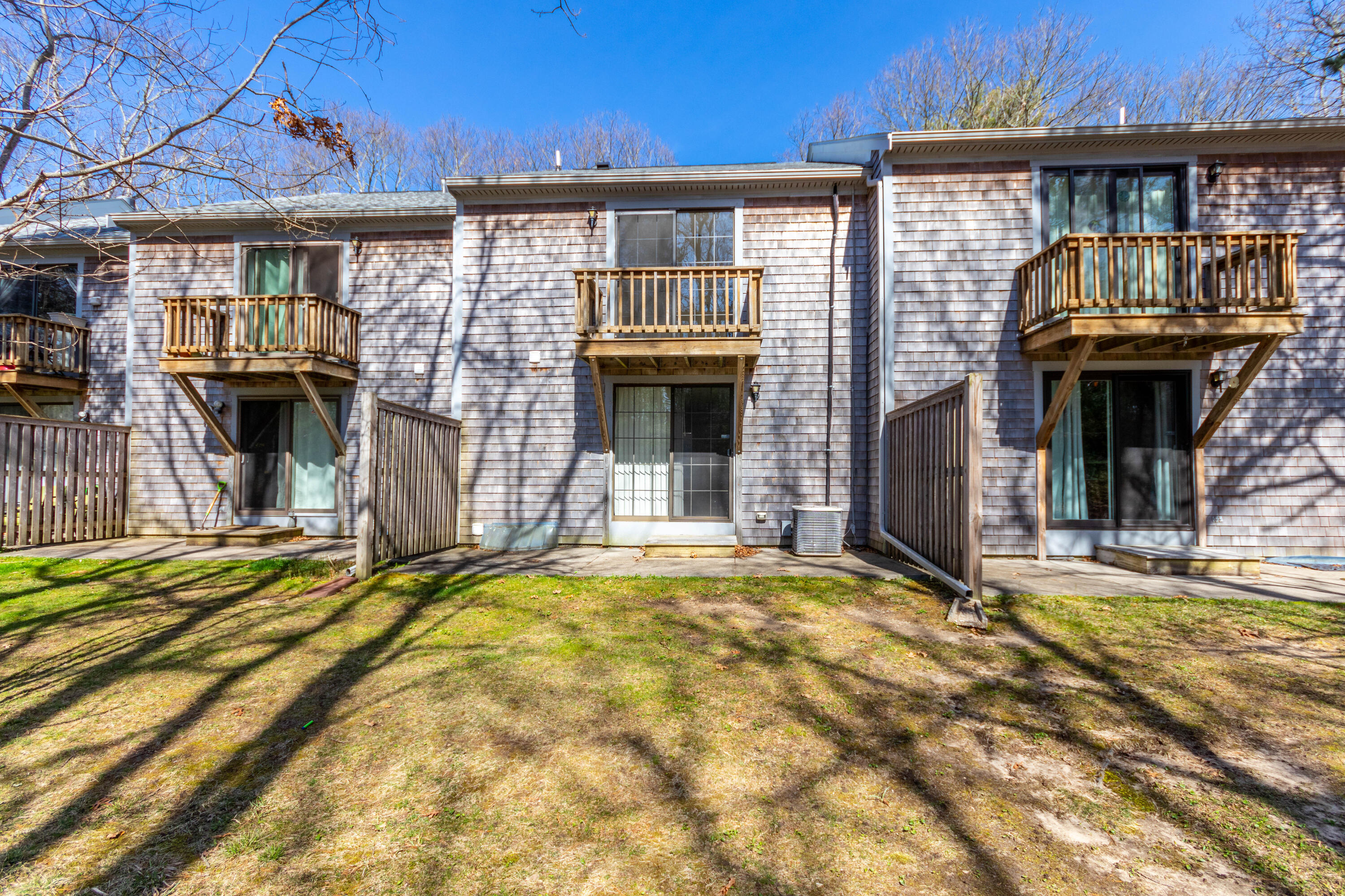 195 Falmouth Road, Unit 5B Mashpee, MA 02649 - Photo 4 of 29 Back of condo with patio area