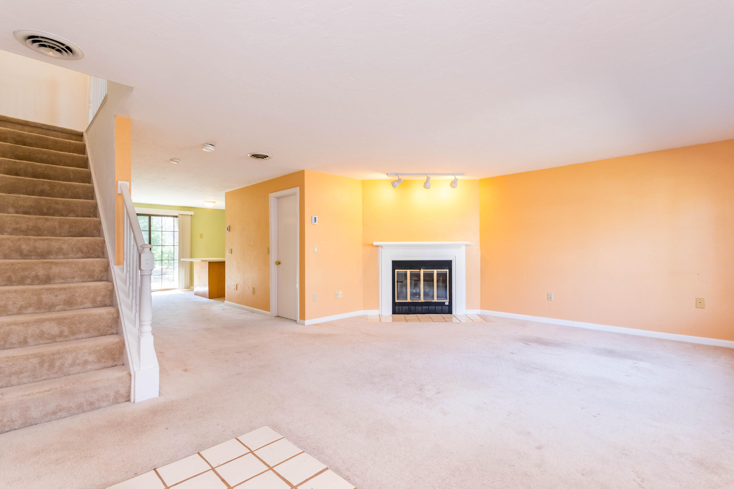195 Falmouth Road, Unit 5B Mashpee, MA 02649 - Photo 6 of 29 Living room with fireplace