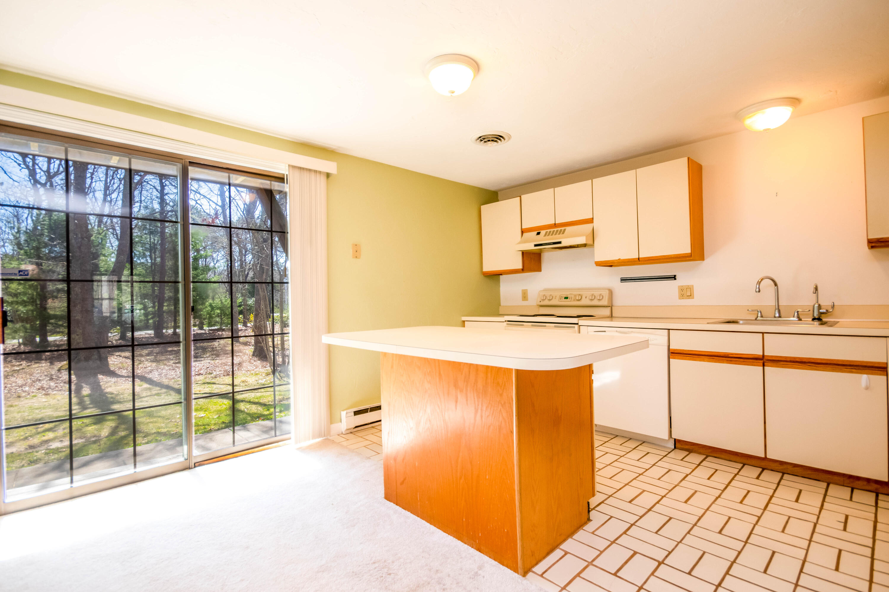 195 Falmouth Road, Unit 5B Mashpee, MA 02649 - Photo 8 of 29 Kitchen with slider to patio