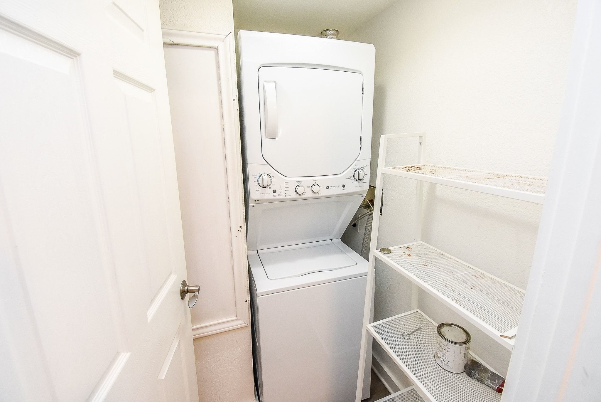1404 Welch Street, Unit 2 Houston, TX 77006 - Photo 20 of 20 Convenient in-unit stacked washer and dryer with additional storage shelving for everyday functionality.