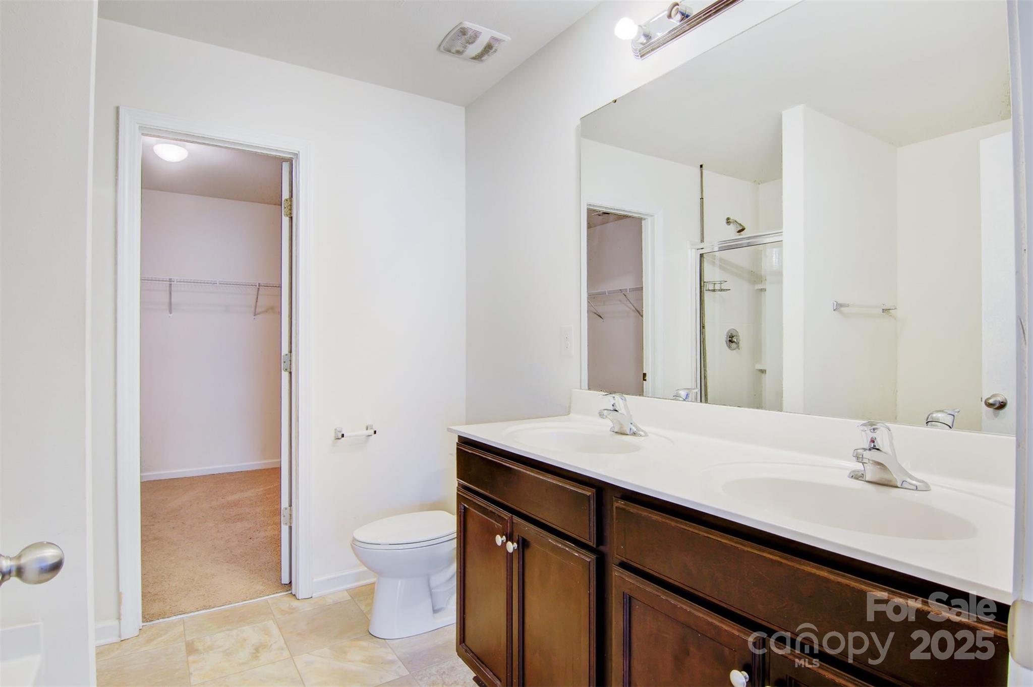 5311 Oakdale Ridge Road Charlotte, NC 28216 - Photo 19 of 35 a bathroom with a sink a toilet and shower