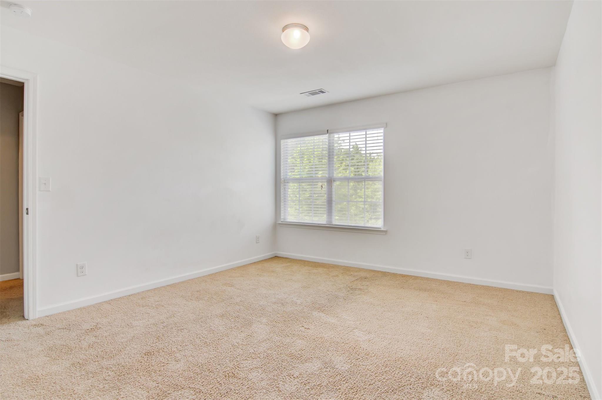 5311 Oakdale Ridge Road Charlotte, NC 28216 - Photo 23 of 35 an empty room with windows
