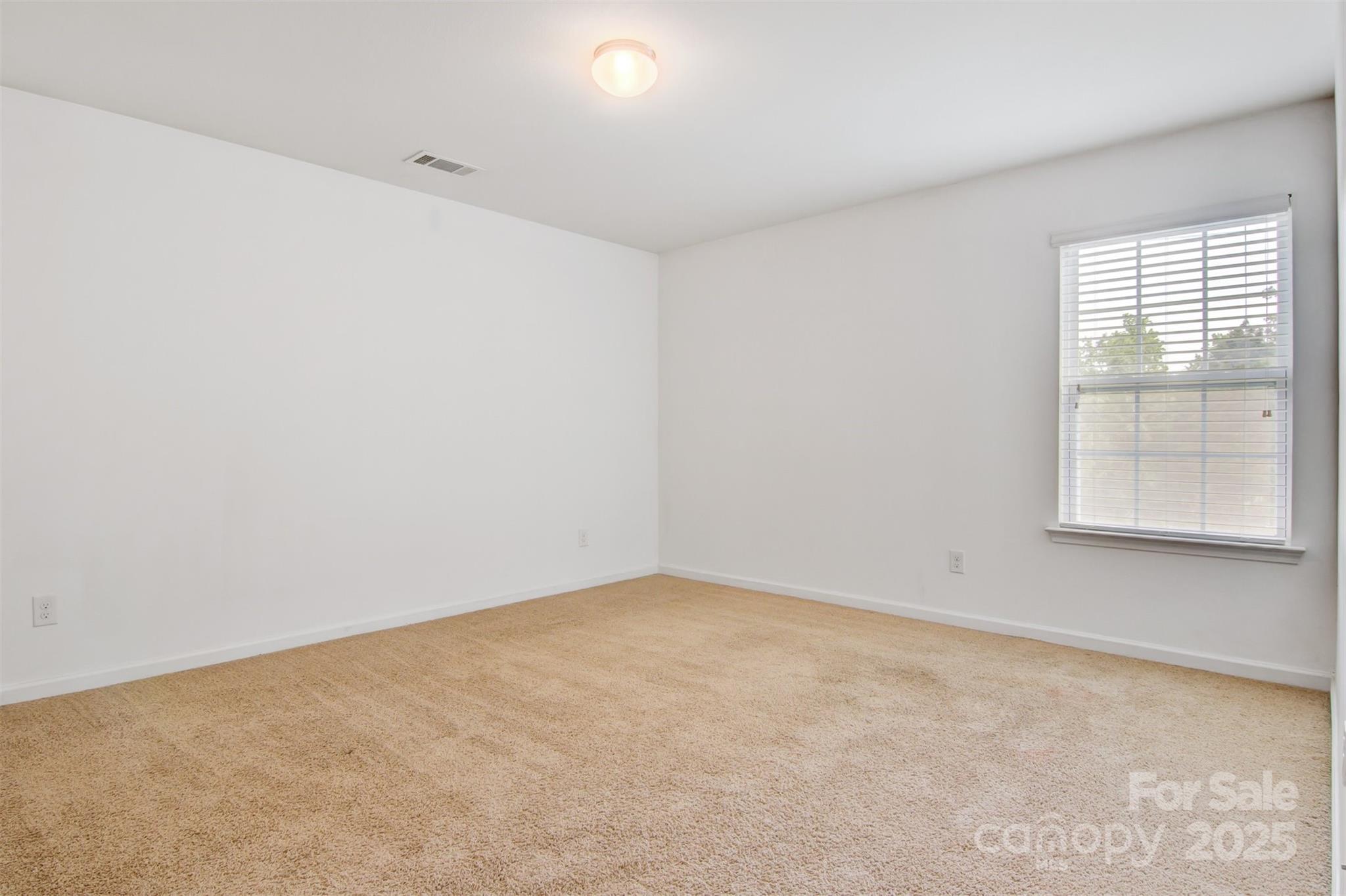 5311 Oakdale Ridge Road Charlotte, NC 28216 - Photo 24 of 35 an empty room with a window