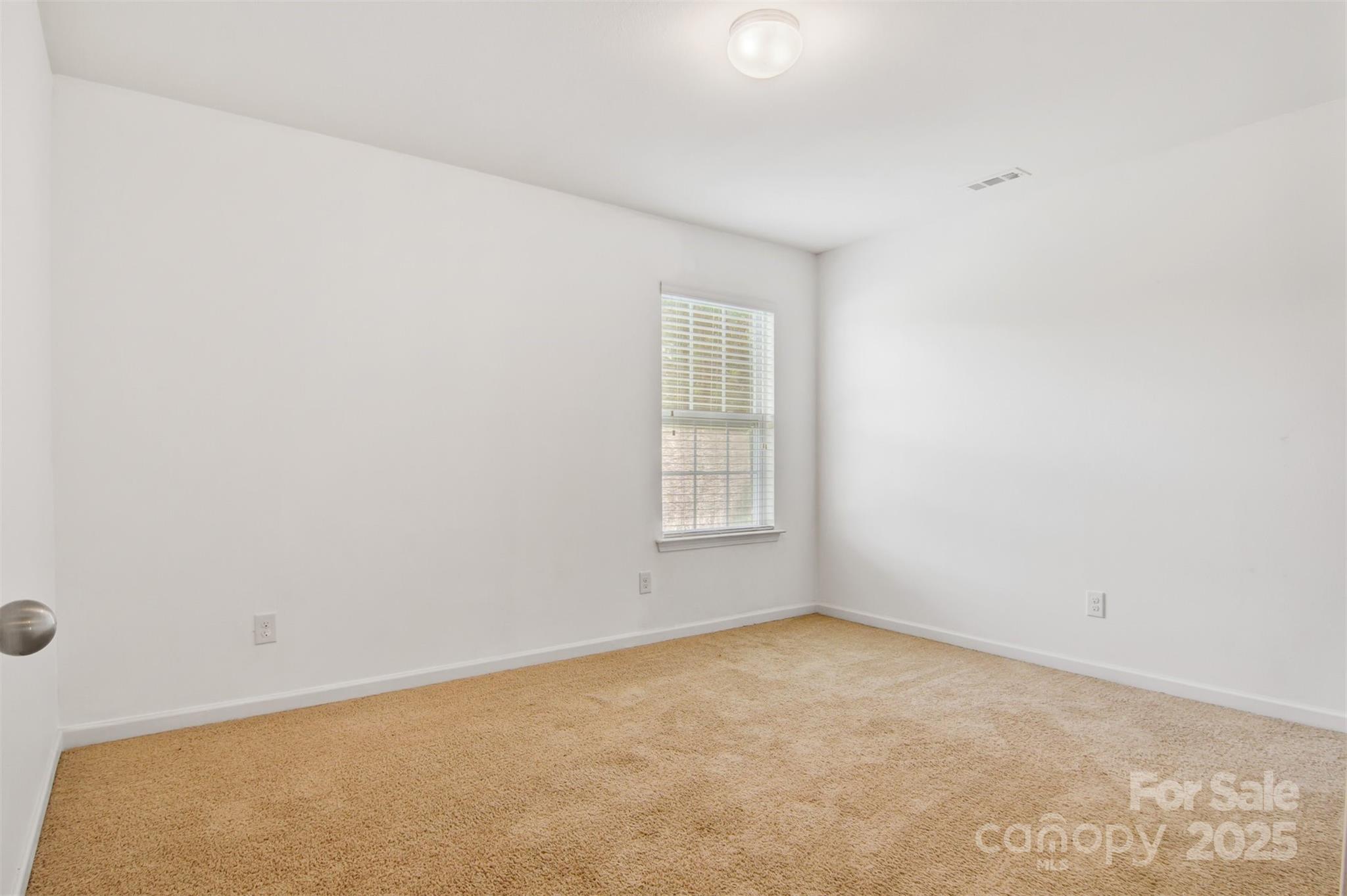 5311 Oakdale Ridge Road Charlotte, NC 28216 - Photo 25 of 35 an empty room with a window