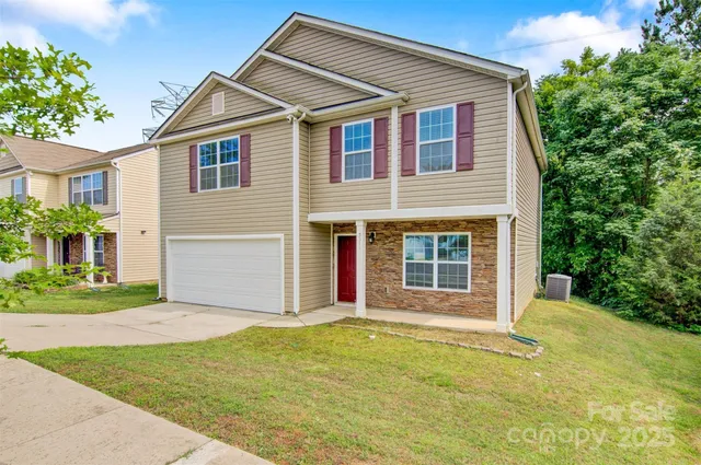 a front view of a house with a garden