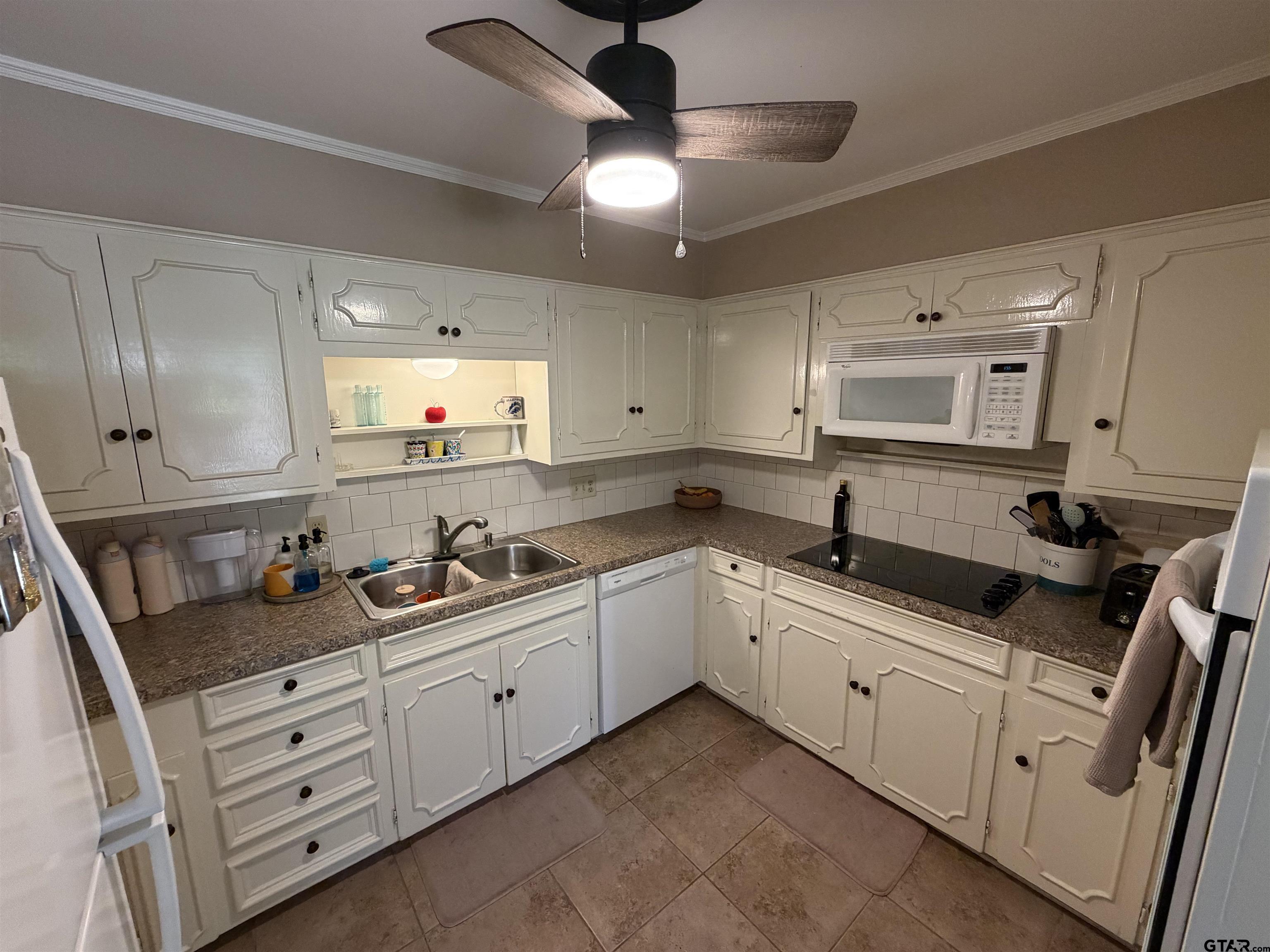 5704 Foxcroft Road Tyler, TX 75703 - Photo 5 of 10 a kitchen with granite countertop white cabinets and white appliances