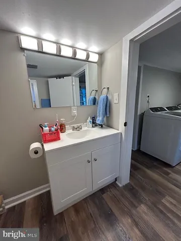 a bedroom with a bed and a flat tv screen on dresser