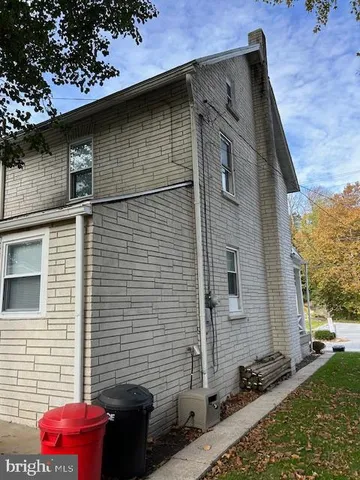a brick house with a small backyard