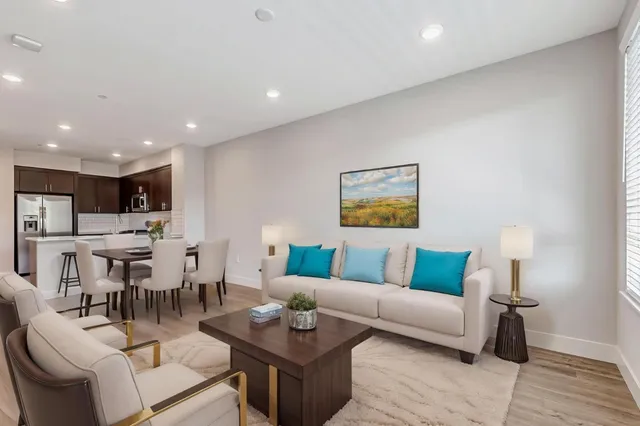 a living room with furniture and kitchen view