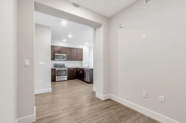 a view of a kitchen with a sink and a stove top oven