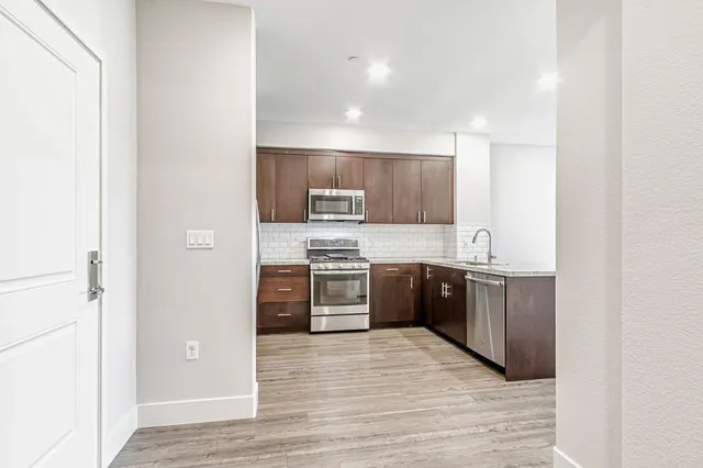a large kitchen with a stove top oven and refrigerator