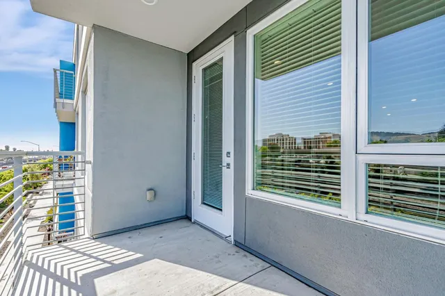a view of a balcony and a yard