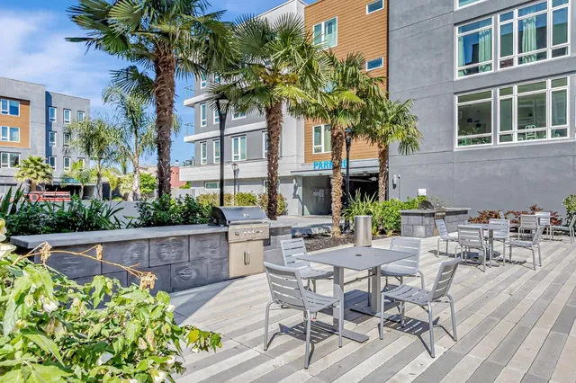 a view of a patio with table and chairs and potted plants