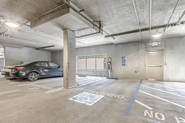 a view of parking garage with a car parked in it