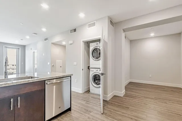 a view of a kitchen with a sink and wooden floor