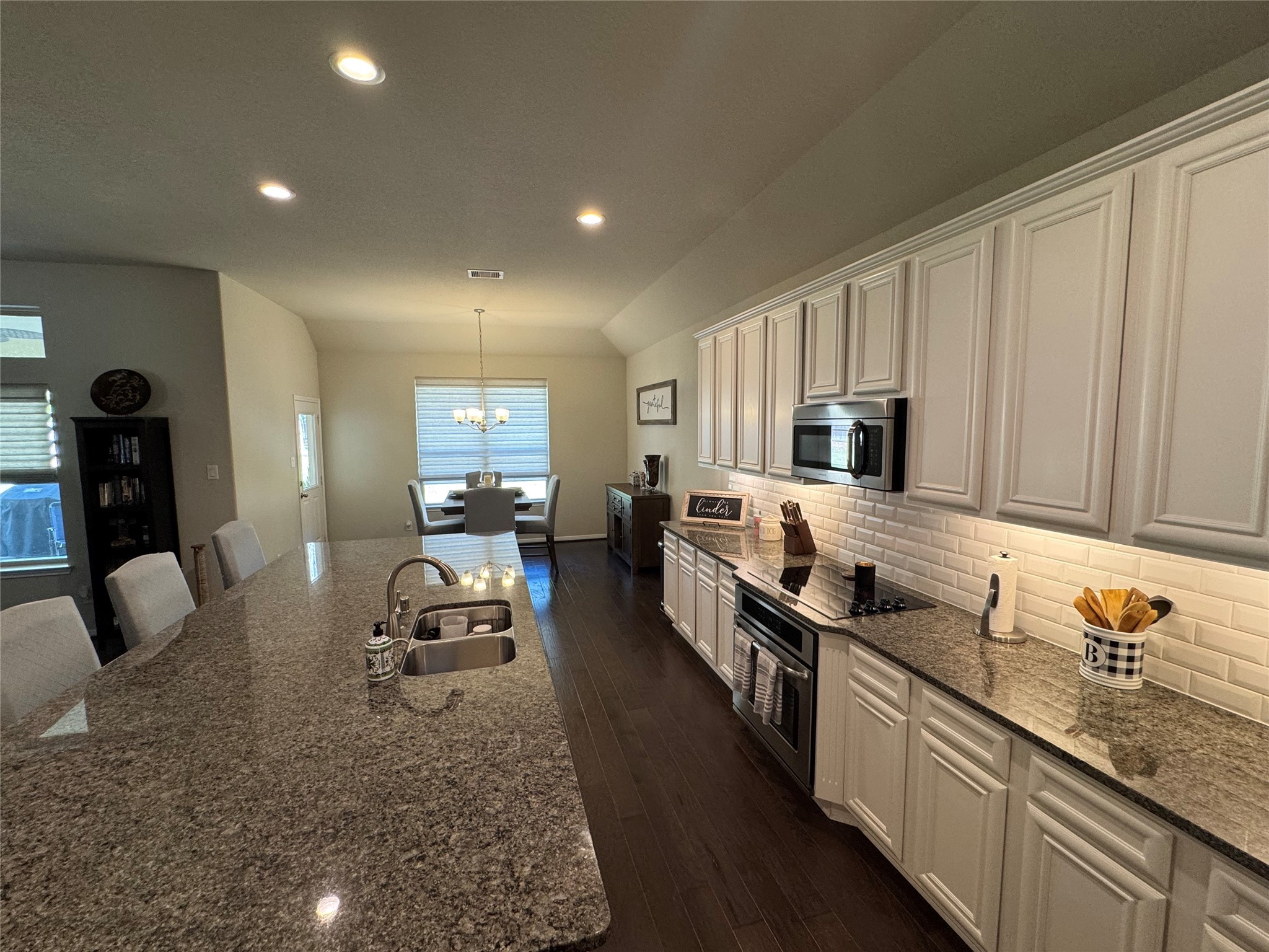 4507 Axis Trail Conroe, TX 77303 - Photo 12 of 34 a kitchen with granite countertop lots of counter top space and stainless steel appliances