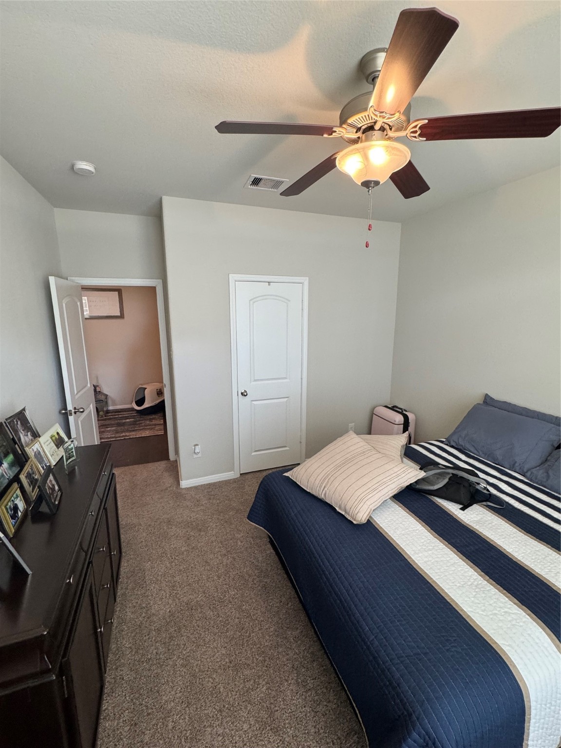 4507 Axis Trail Conroe, TX 77303 - Photo 19 of 34 a bedroom with a bed and a chandelier