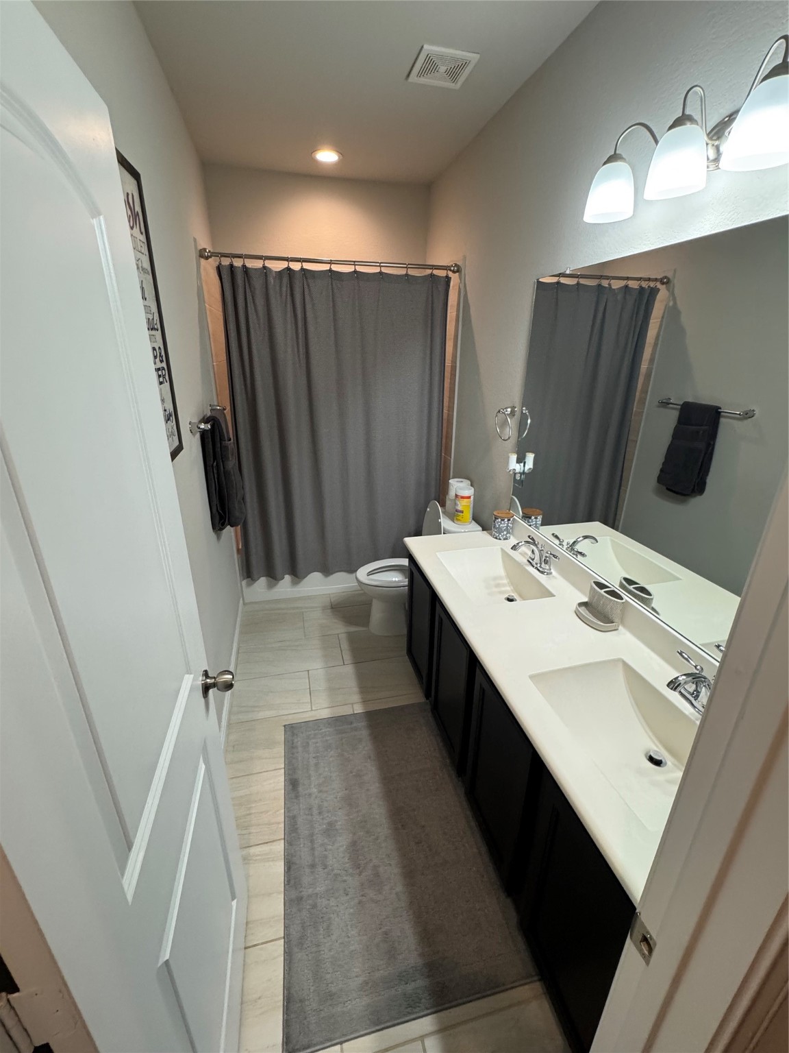 4507 Axis Trail Conroe, TX 77303 - Photo 23 of 34 a en suite bathroom with a double vanity sink and a mirror