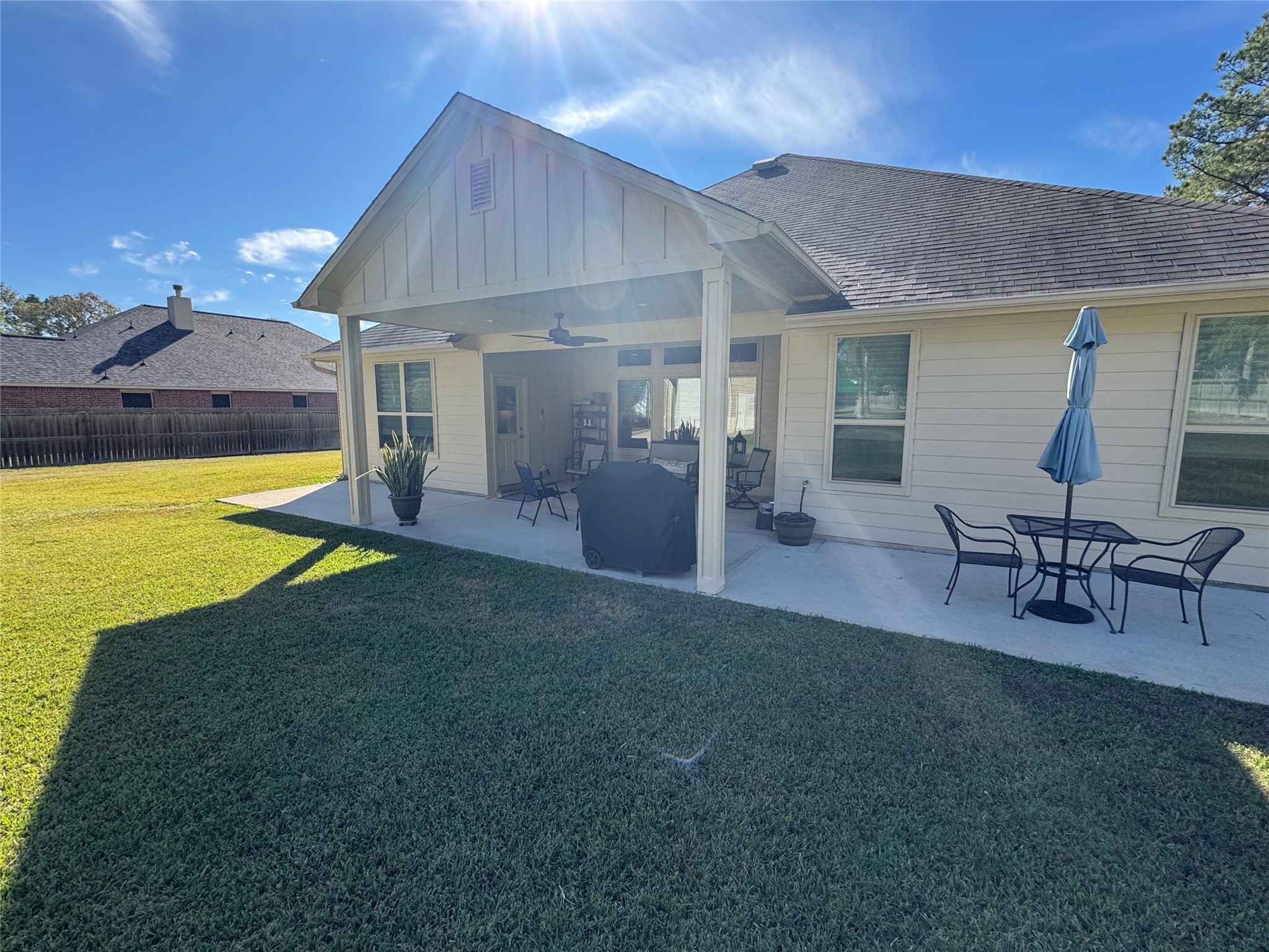 4507 Axis Trail Conroe, TX 77303 - Photo 30 of 34 a view of a patio with table and chairs under an umbrella
