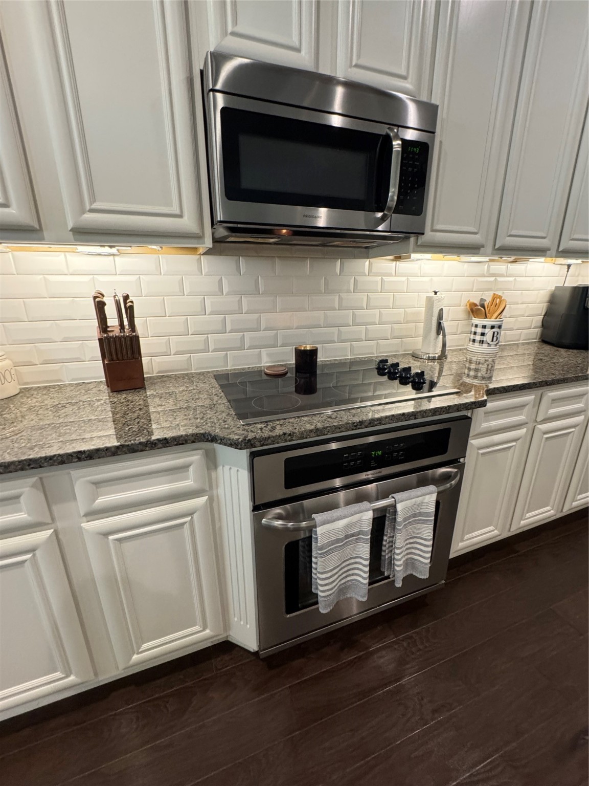 4507 Axis Trail Conroe, TX 77303 - Photo 9 of 34 a kitchen with stainless steel appliances a stove a microwave a sink and cabinets