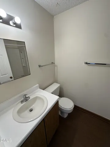 a bathroom with a sink a toilet and mirror