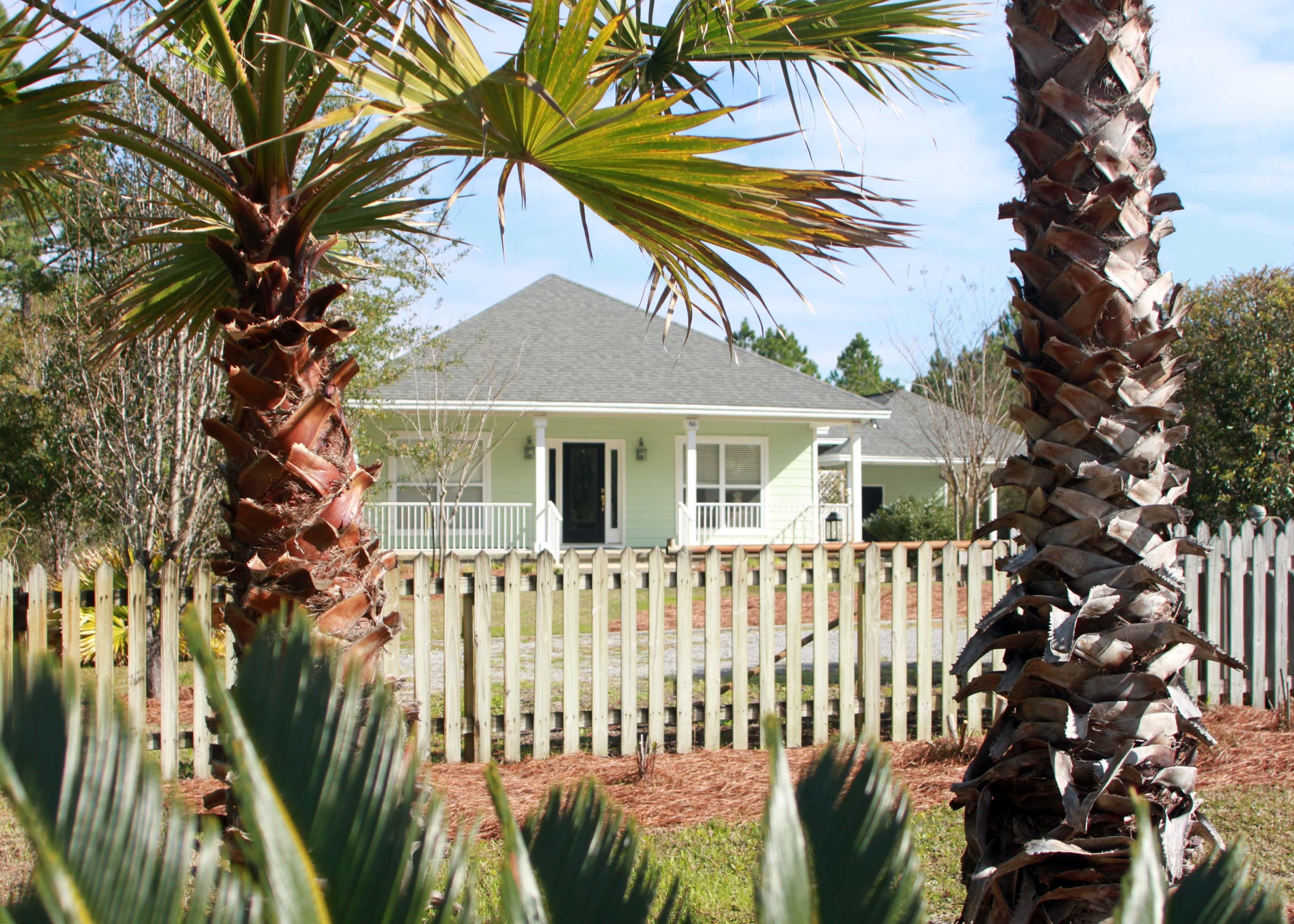86 West Nursery Road Santa Rosa Beach, FL 32459 - Photo 1 of 20 a front view of a house with a garden