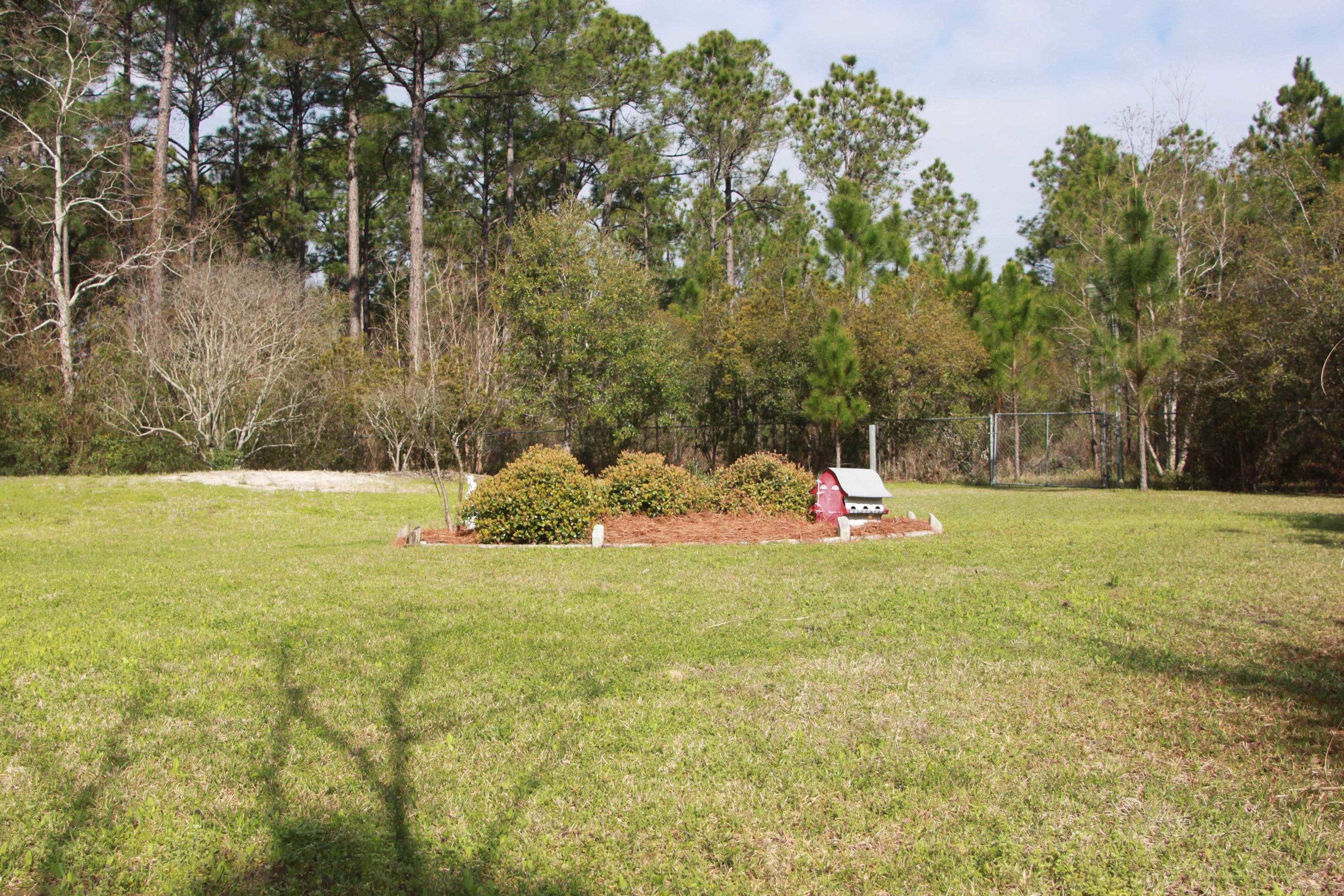 86 West Nursery Road Santa Rosa Beach, FL 32459 - Photo 3 of 20 a backyard of a house with lots of green space
