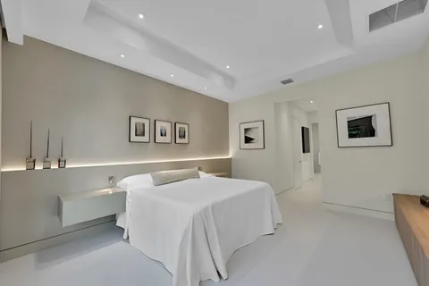 a bedroom with a bed and a night stand