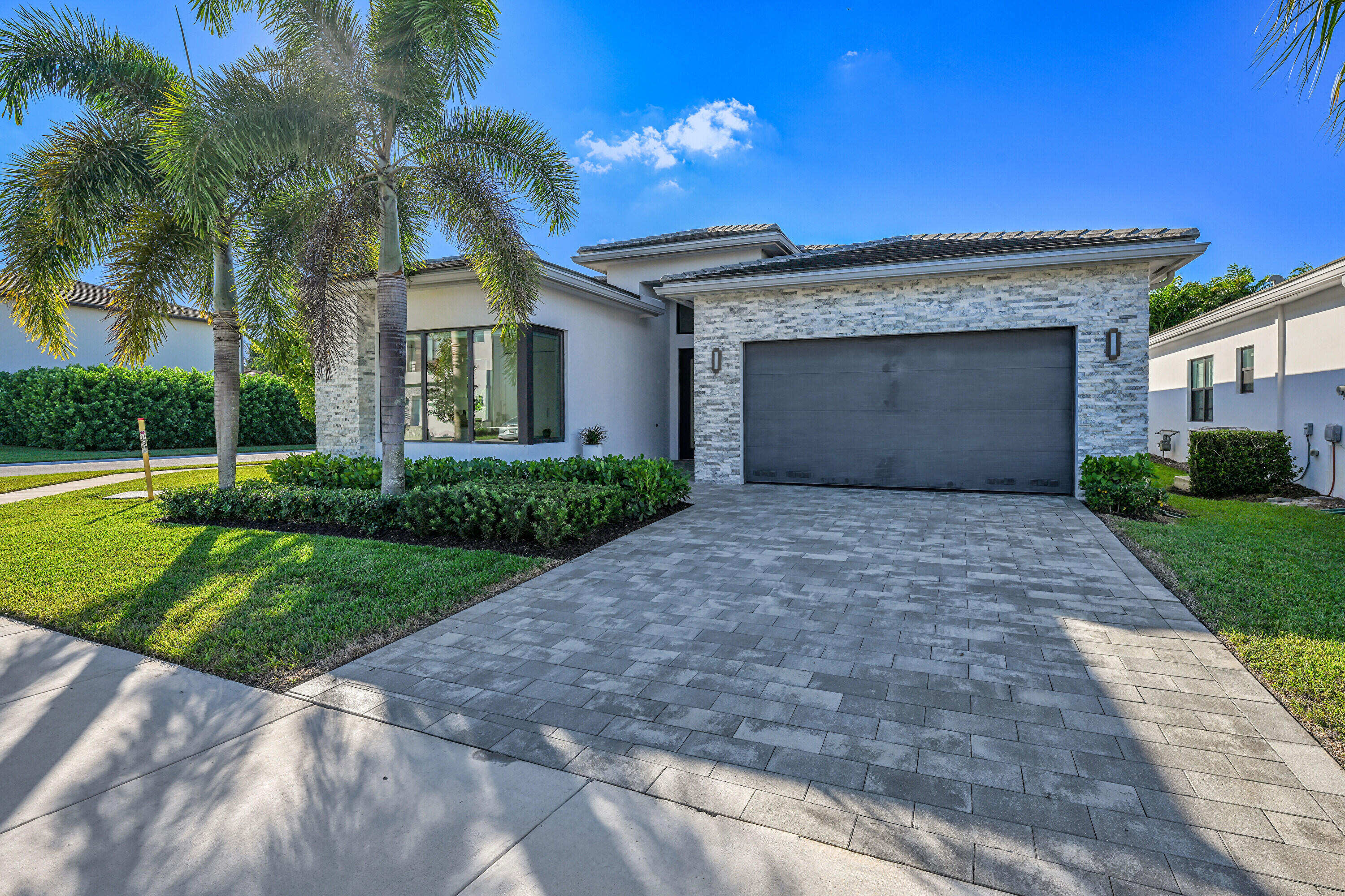 8538 Apple Falls Lane Boca Raton, FL 33496 - Photo 2 of 28 a front view of a house with a yard and garage