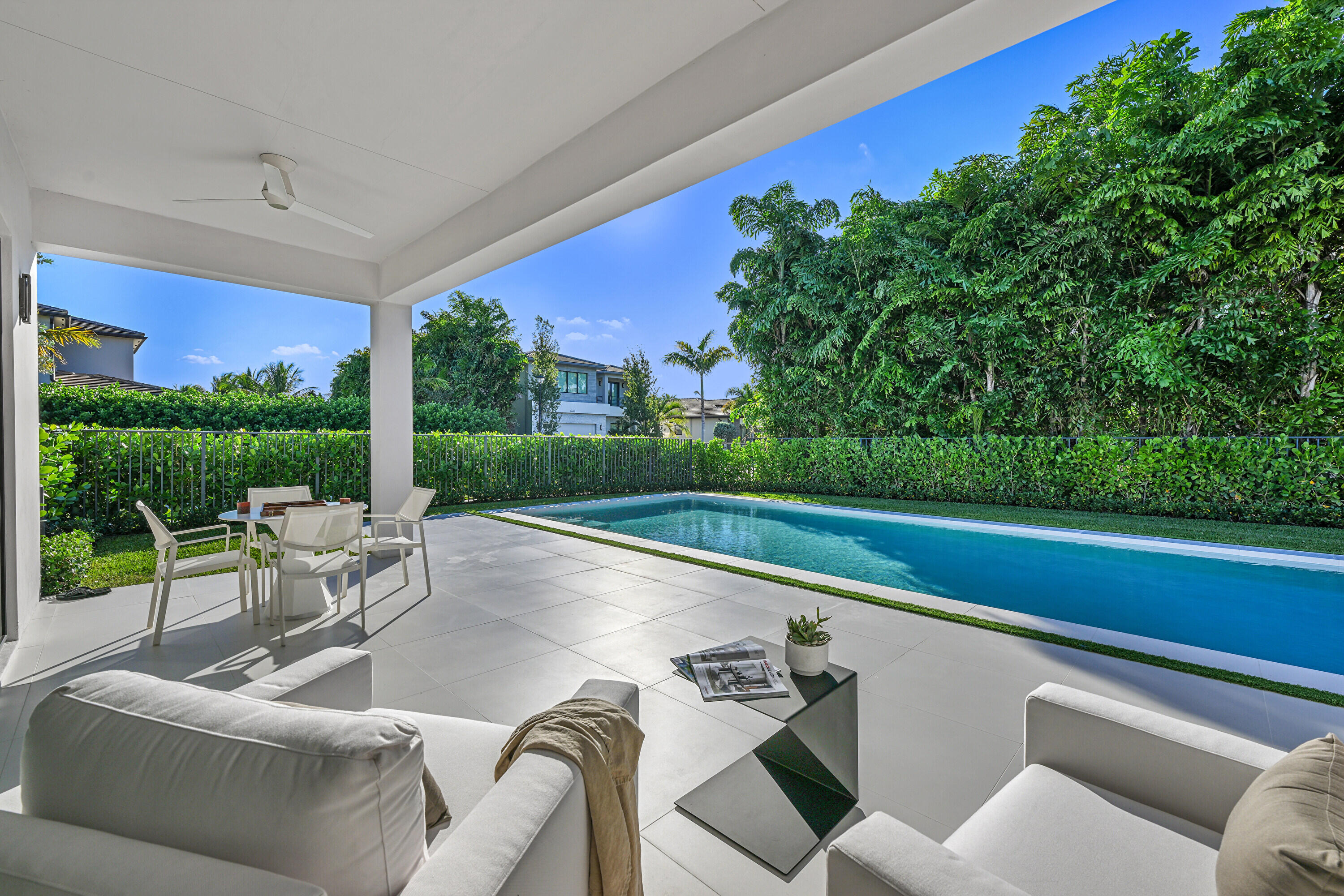 8538 Apple Falls Lane Boca Raton, FL 33496 - Photo 21 of 28 a view of a patio with couches chairs and a table