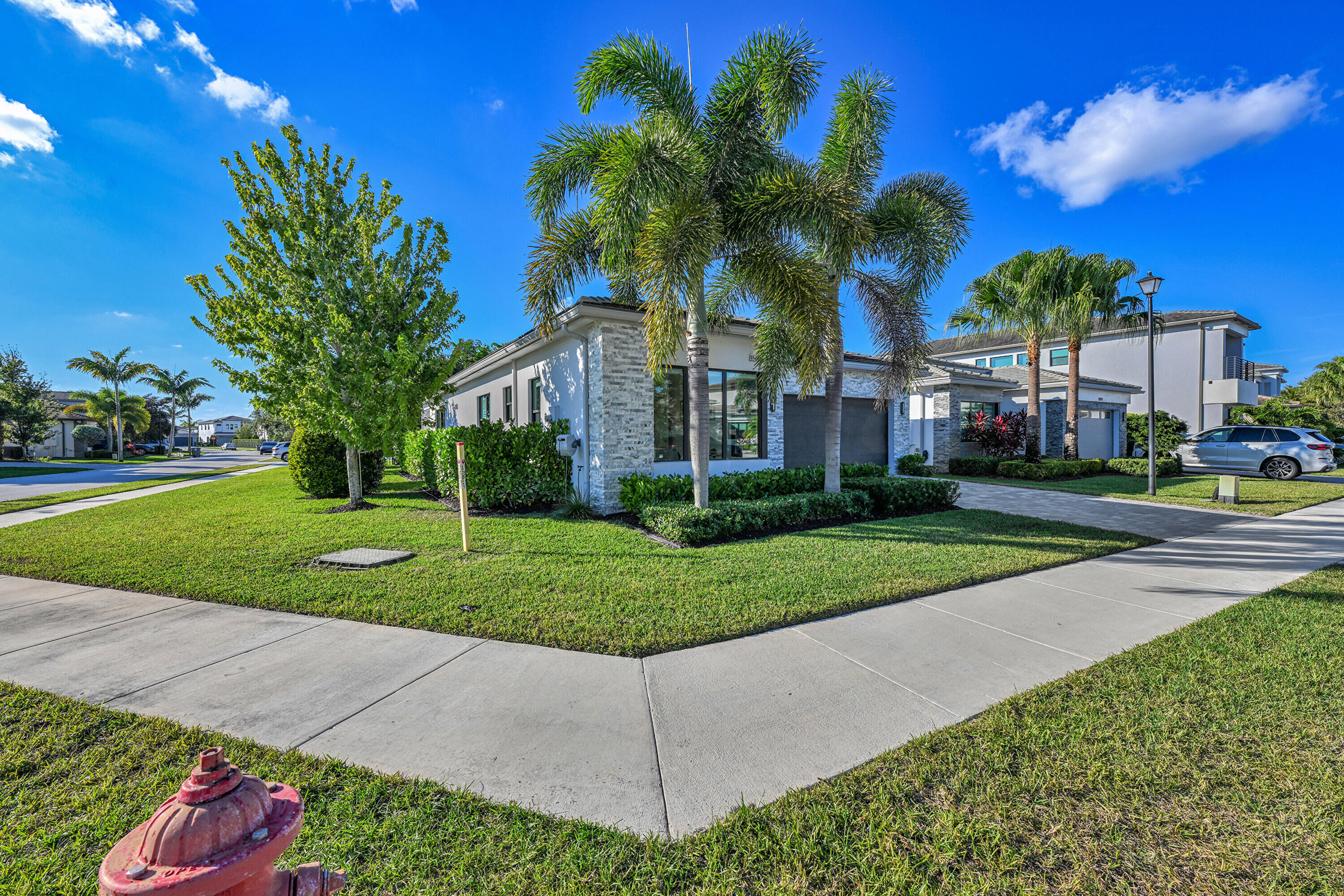 8538 Apple Falls Lane Boca Raton, FL 33496 - Photo 26 of 28 a view of a white house with a yard