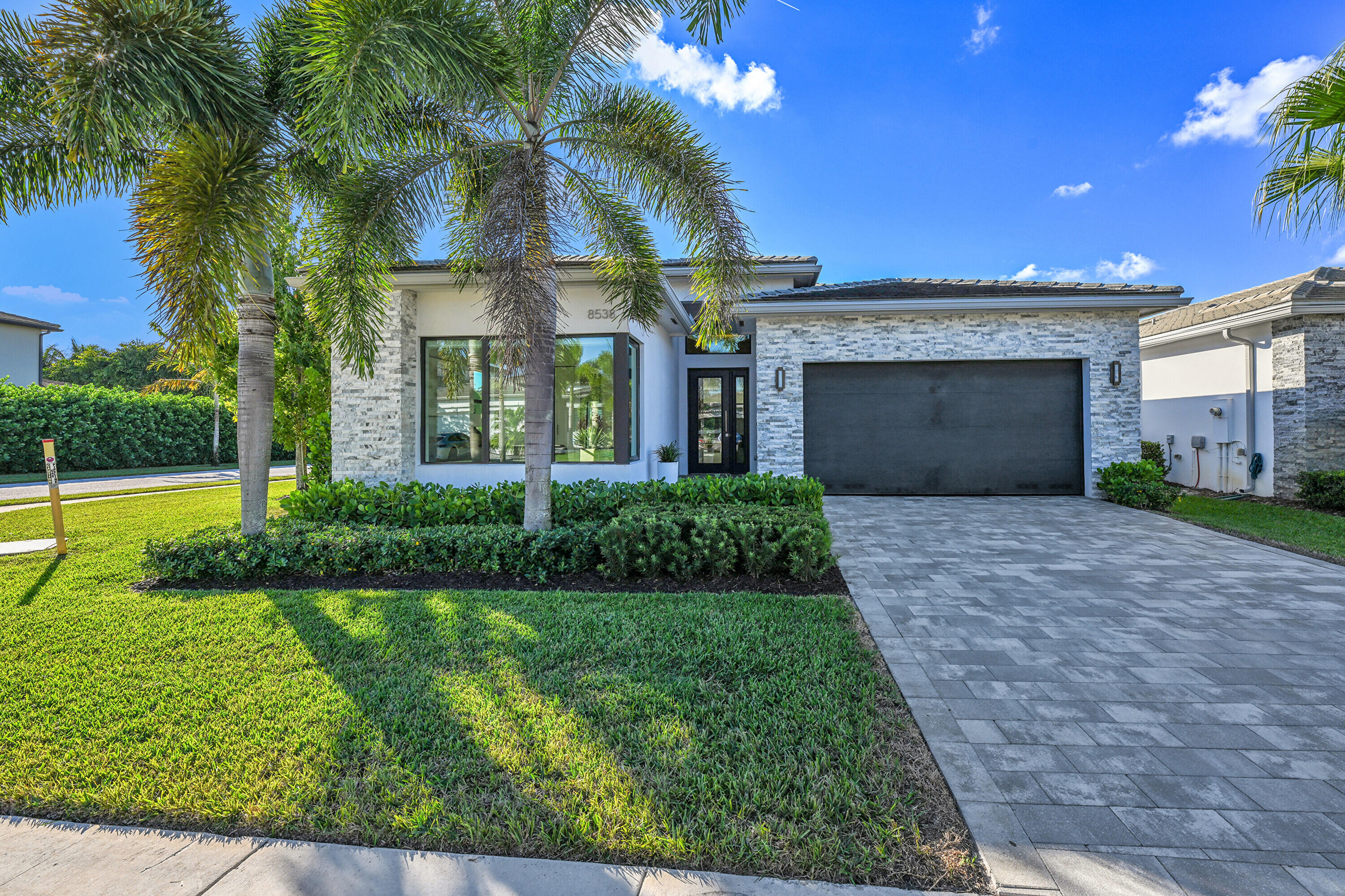 8538 Apple Falls Lane Boca Raton, FL 33496 - Photo 27 of 28 a front view of a house with yard and green space