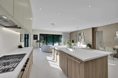 a kitchen with sink stove and refrigerator