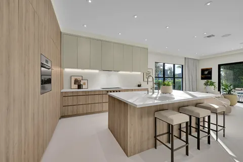 a kitchen with a sink and chairs