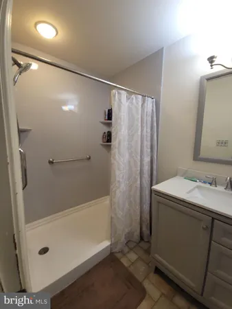 a bathroom with a tub sink and shower