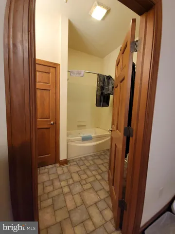 a bathroom with a bathtub and a shower