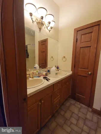 a bathroom with a double vanity sink and mirror