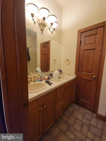 a bathroom with a double vanity sink and mirror