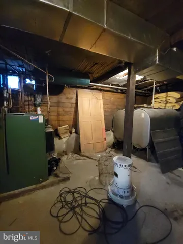 a room with lots of furniture and a potted plant