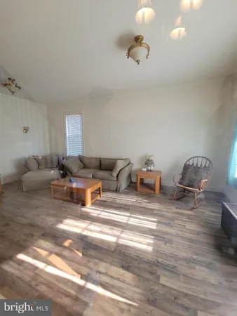 a living room with furniture a rug and a chandelier