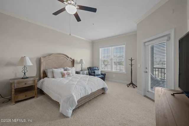 a bedroom with a bed and a large window