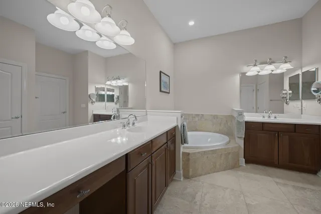 a bathroom with a granite countertop sink a toilet and mirror
